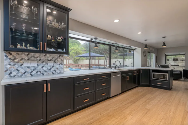 After view of dark cabinets with warm metal hardware