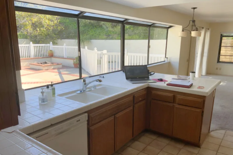 Before view of dark cabinets with warm metal hardware