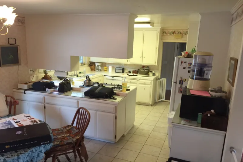 Before view of bright white kitchen cabinet refresh