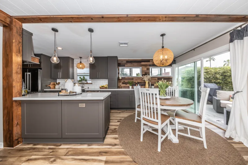 After view of gray kitchen open to dining