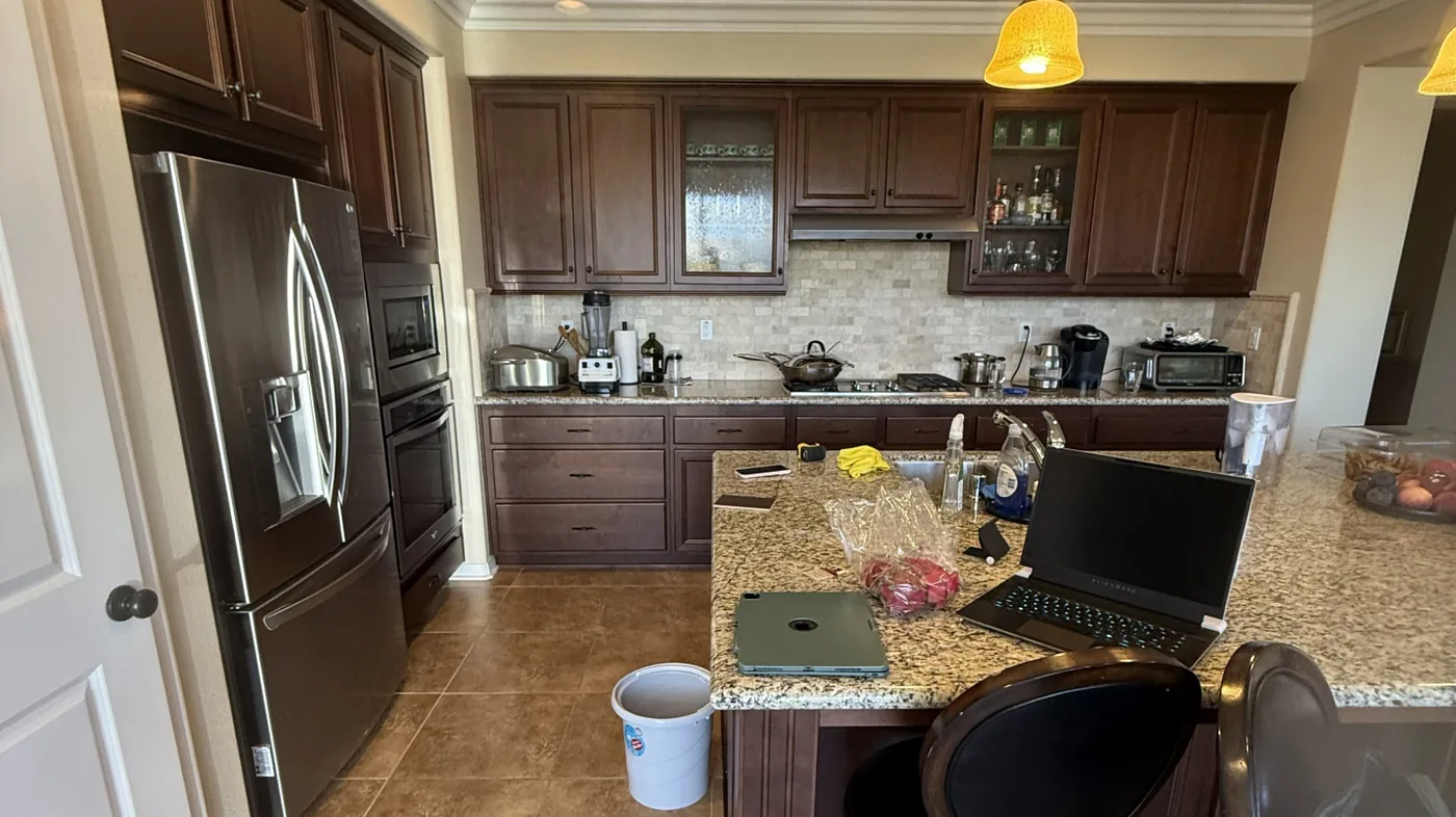 Before view of natural wood cabinets with blue island