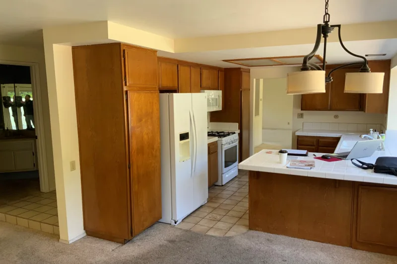 Before view of navy cabinets with stainless appliances