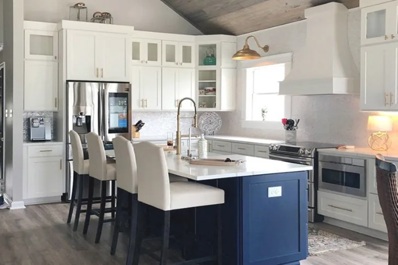After view of white cabinets with a blue island