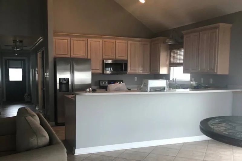 Before view of white cabinets with a blue island