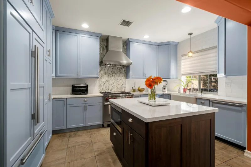 After view of white cabinets with a dark island