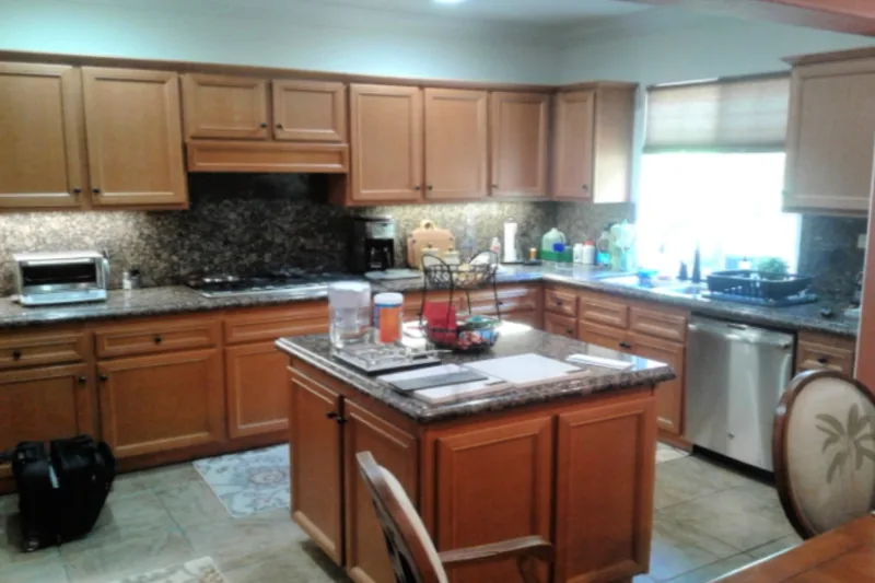 Before view of white cabinets with a dark island