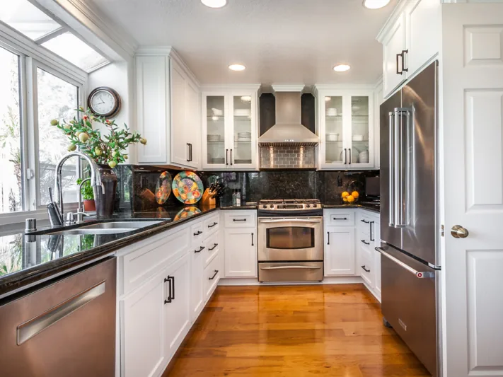 After view of white cabinets with black hardware