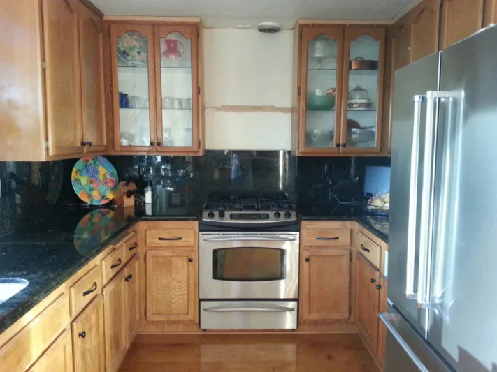 Before view of white cabinets with black hardware