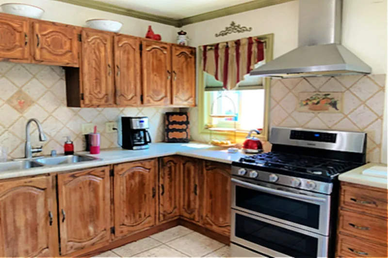Before view of clean white kitchen cabinet makeover