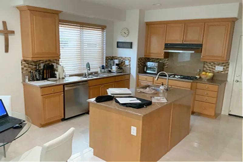 Before view of white kitchen with waterfall island