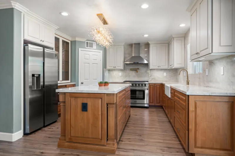After view of white and natural wood two-tone kitchen