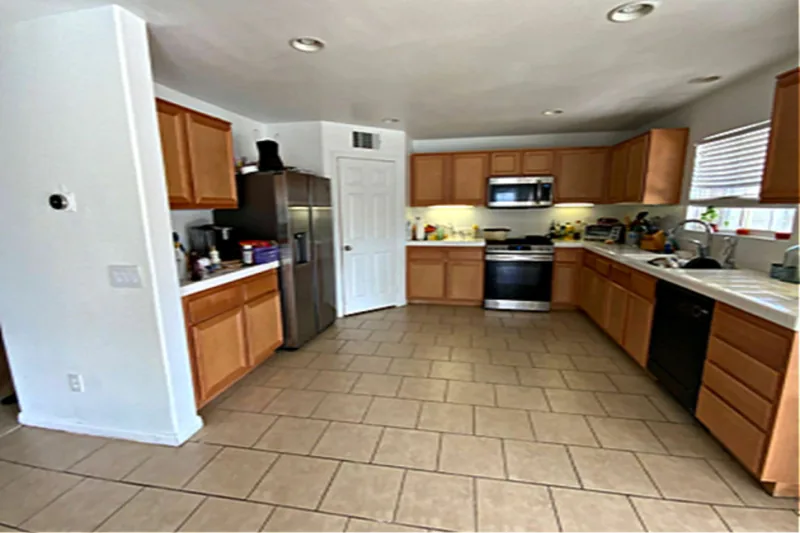 Before view of white and natural wood two-tone kitchen