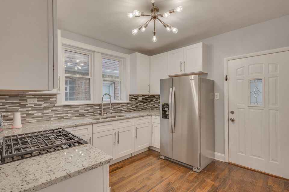 Refinished kitchen cabinets in a bright modern kitchen