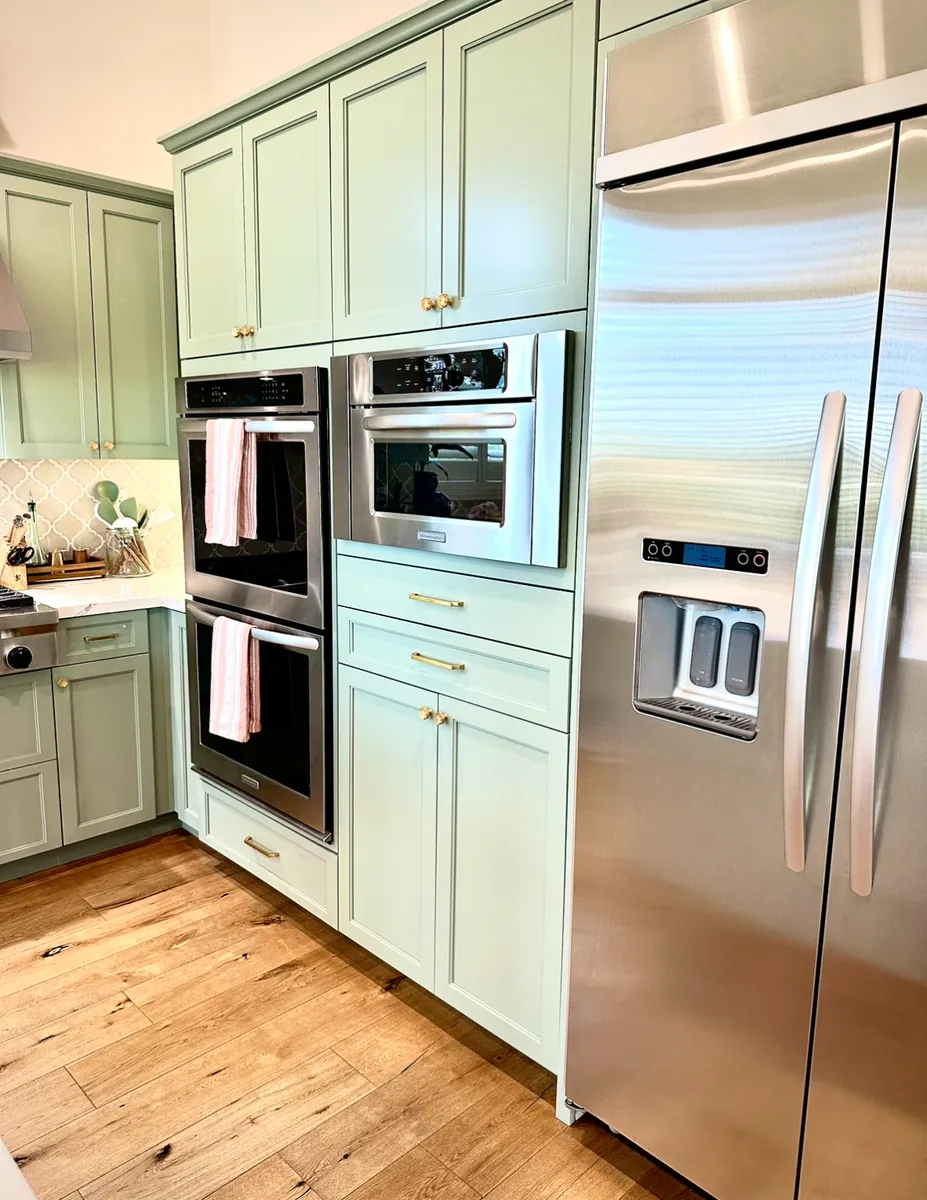 Refinished cabinetry surrounding kitchen appliances
