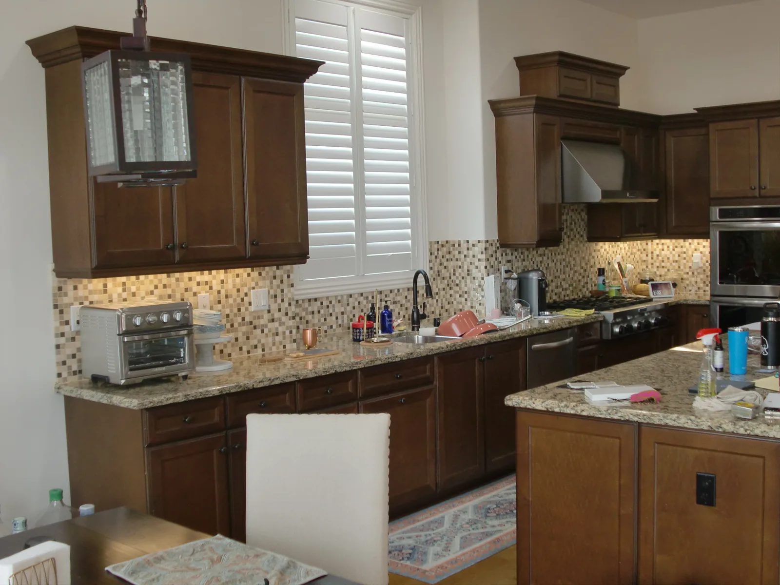 Kitchen before cabinet refinishing with dark stained cabinets