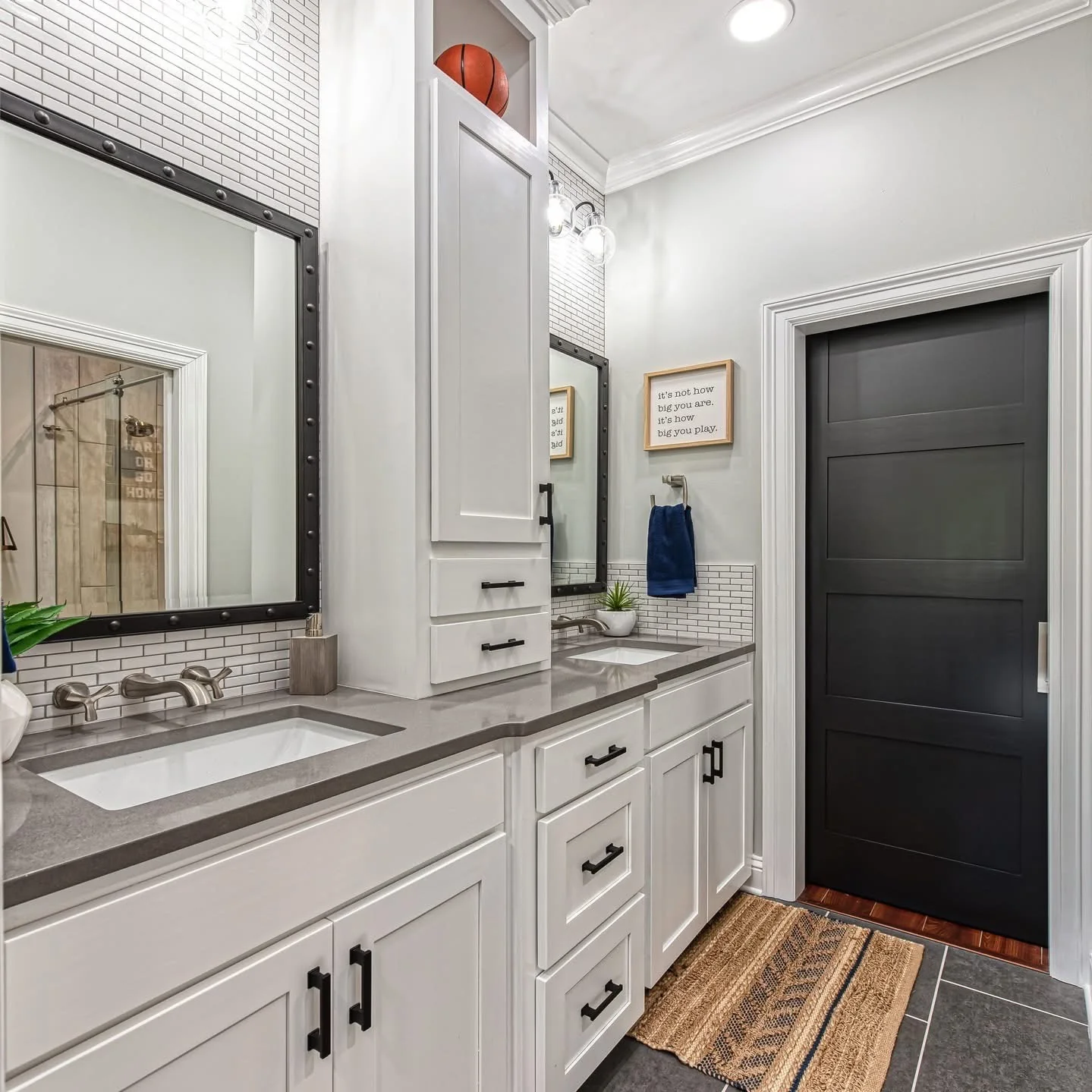 Gray bathroom vanity cabinetry with black hardware