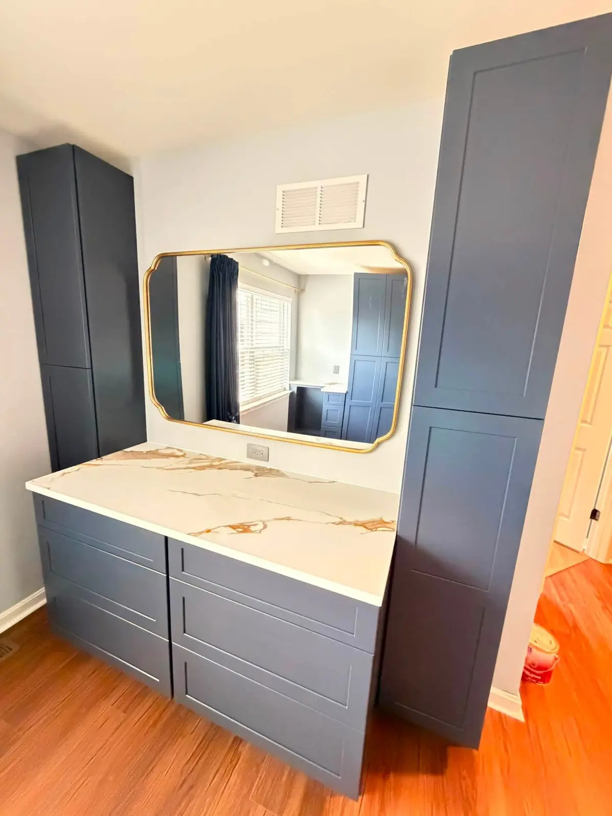 Navy vanity cabinetry with a bright stone top