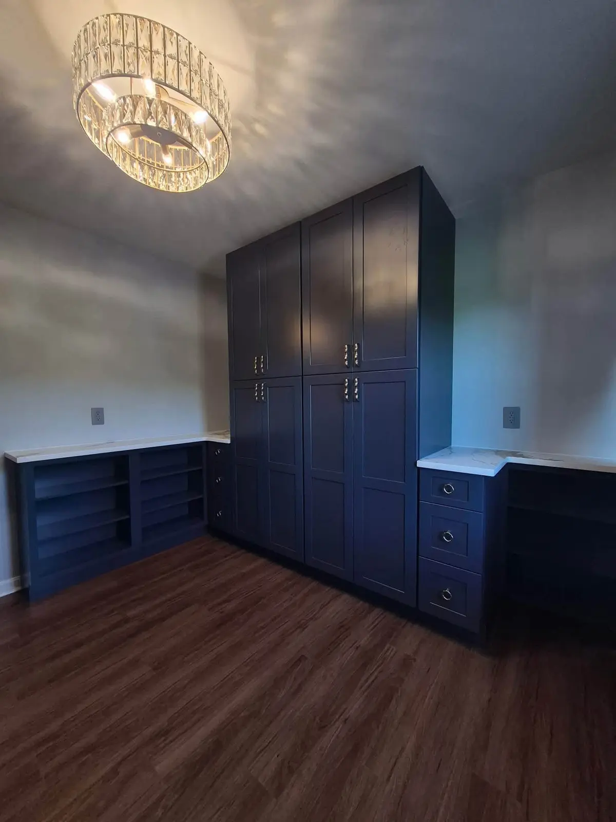 Dark navy built-ins designed for a full wall