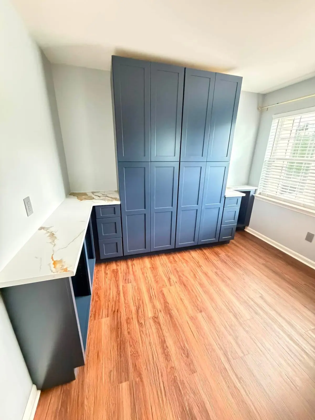 Floor-to-ceiling navy built-in cabinet storage