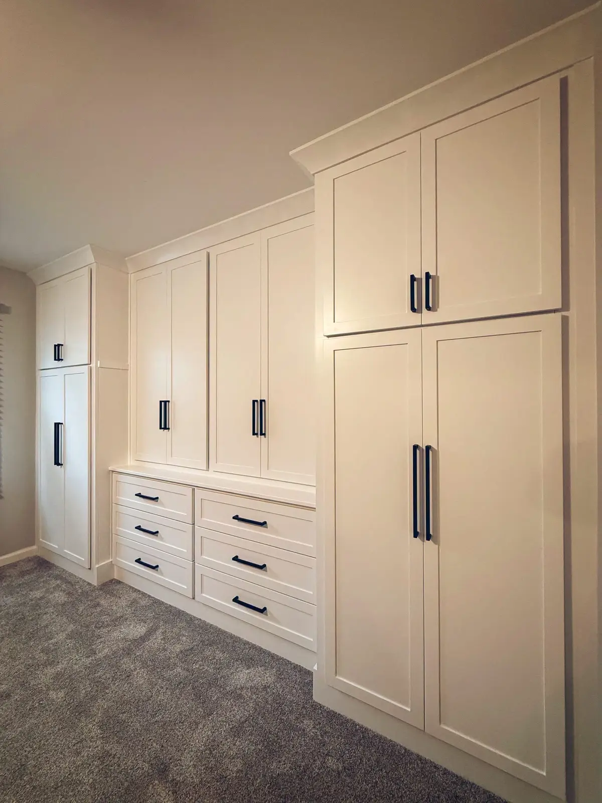 Floor-to-ceiling white bedroom storage