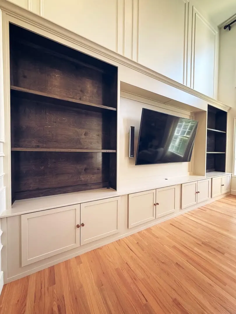 White entertainment-center cabinetry with open shelving