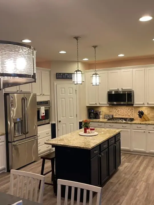 White kitchen cabinetry with navy island
