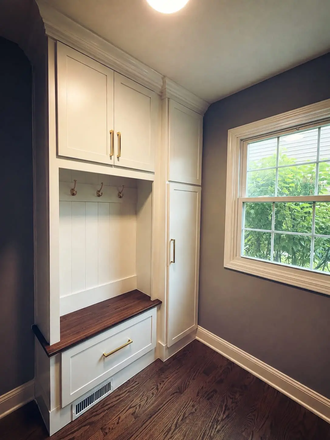 White built-in storage and a window seat